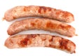 Three fried chipolata sausages on a white Royalty Free Stock Photo