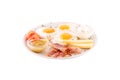 Three fried eggs garnished with cheese, ham and tomatoes