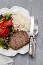 three fried ground meat with fresh salad and rice on white plate Royalty Free Stock Photo