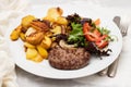 three fried ground meat with fried potato and salad on white plate Royalty Free Stock Photo