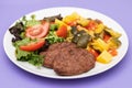 three fried ground meat with vegetables and fresh salad on white plate Royalty Free Stock Photo