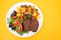 three fried ground meat with vegetables and fresh salad on white plate Royalty Free Stock Photo