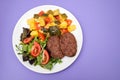 three fried ground meat with vegetables and fresh salad on white plate Royalty Free Stock Photo