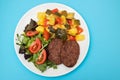 three fried ground meat with vegetables and fresh salad on white plate Royalty Free Stock Photo