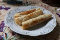 three rolled pancakes on a plate Royalty Free Stock Photo