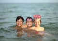 Three friendly brothers swimming in the sea