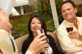 Three Friends Enjoying Wine on the Patio Royalty Free Stock Photo