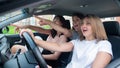 Three friends go on a trip. Caucasian women drive in a car and point fingers in surprise. Royalty Free Stock Photo