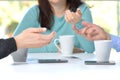 Three friends hands talking in a bar with phone on the table Royalty Free Stock Photo