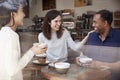 Three friends having coffee and laughing at a coffee shop Royalty Free Stock Photo