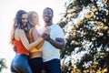 Three friends having fun dancing kizomba on a meadow