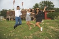 Three Friends Jumping, Laughing and Having Fun in the Ranch