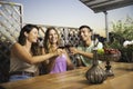 Three Friends Laughing and Cheering With Glasses of Wine at The Balcony Royalty Free Stock Photo