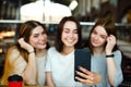 Three friends make selfie and drink coffee at cafe Royalty Free Stock Photo