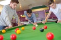 three friends playing pool Royalty Free Stock Photo