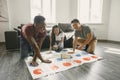 Three friends playing twister in the living room Royalty Free Stock Photo