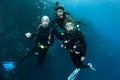 Three friends scuba diving together Royalty Free Stock Photo