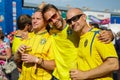 Three friends supporting of Sweden football team.