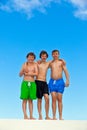 Three friends in swimmware stick together Royalty Free Stock Photo