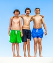 Three friends in swimware stick together Royalty Free Stock Photo