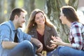 Three friends talking sitting in a park