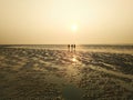 Three friends are walking on the beach of Chandipur