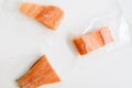 Three frozen salmon fish fillet package in small plastic bags