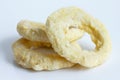 Three frozen uncooked battered onion or calamari rings isolated