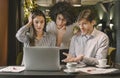 Three frustrated business people looking at laptop