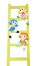 Three funny doll on a wooden ladder Royalty Free Stock Photo