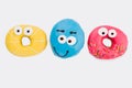 Three funny donuts on white background. Royalty Free Stock Photo