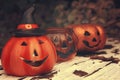 Three funny Halloween pumpkins on wood desk. Autumn mood photo Royalty Free Stock Photo