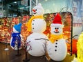 Three funny snowmen on stage at the mall