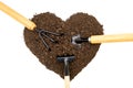 Three garden hand tools in a heart shaped pile of soil Royalty Free Stock Photo