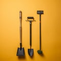 three gardening tools on an orange background