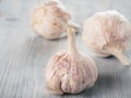 Three garlic bulb close up on gray wooden table Royalty Free Stock Photo