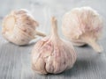 Three garlic bulb close up on gray wooden table Royalty Free Stock Photo