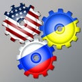 Three gear wheels, painted in the colors of the flag of Russia, Ukraine and the USA Royalty Free Stock Photo