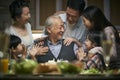 Three generation asian family celebrating grandpa`s birthday at home Royalty Free Stock Photo