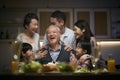 Three generation asian family celebrating grandpa`s birthday at home Royalty Free Stock Photo