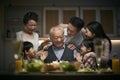 Three generation asian family celebrating grandpa`s birthday at home Royalty Free Stock Photo