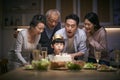 Three generation asian family celebrating little boy`s birthday at home Royalty Free Stock Photo