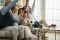 Three generation asian family watching soccer game telecast on tv together at home Royalty Free Stock Photo