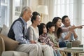 Three generation asian family watching tv together at home Royalty Free Stock Photo