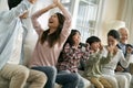 Three generation asian family watching soccer game telecast on tv together at home Royalty Free Stock Photo