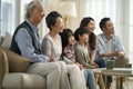 Three generation asian family watching tv together at home Royalty Free Stock Photo