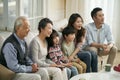 Three generation asian family watching tv together at home Royalty Free Stock Photo