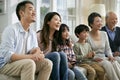 Three generation asian family watching tv together at home Royalty Free Stock Photo