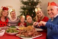 Three Generation Family Enjoying Christmas Meal Royalty Free Stock Photo