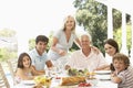 Three Generation Family Enjoying Meal Outdoors Royalty Free Stock Photo